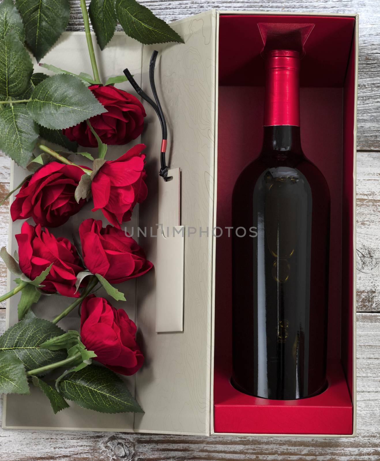 Happy Valentines Day with red roses and wine in a gift box 