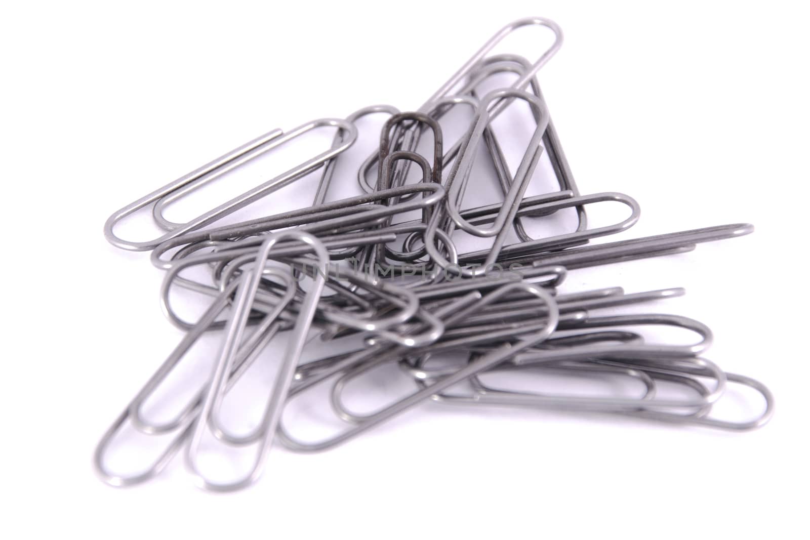 a lot of paper clips are metal-insulated on the white background