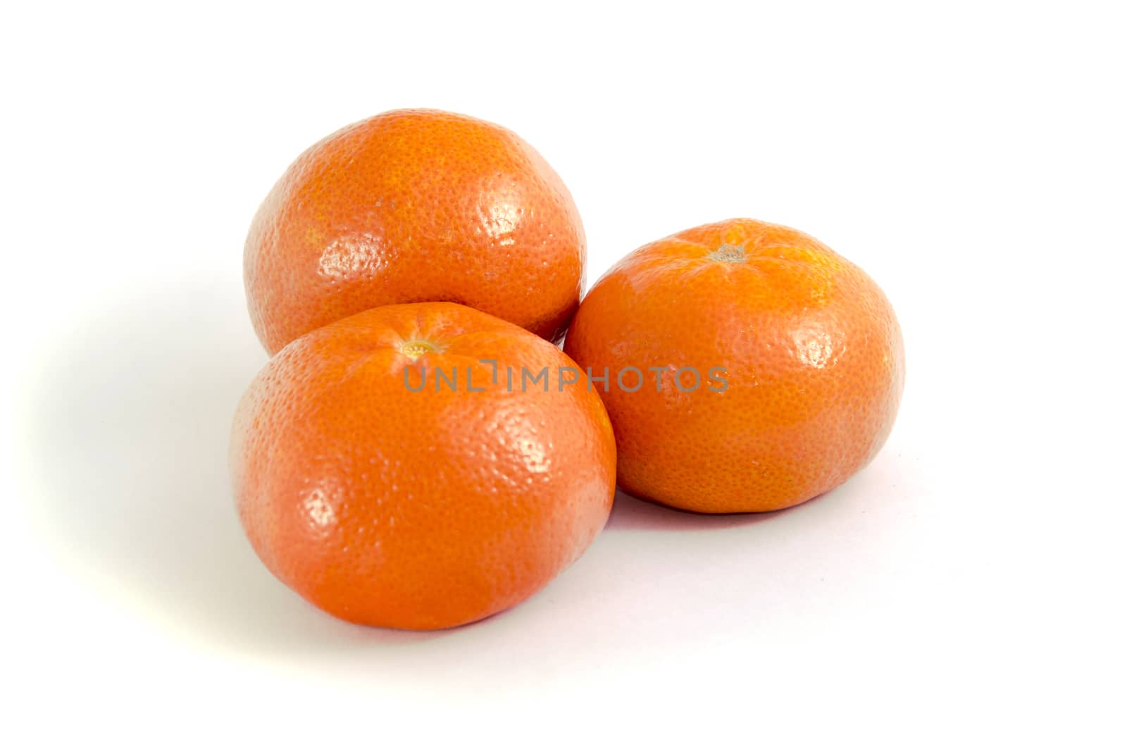 three orange Mandarin with shadow on white isolated background