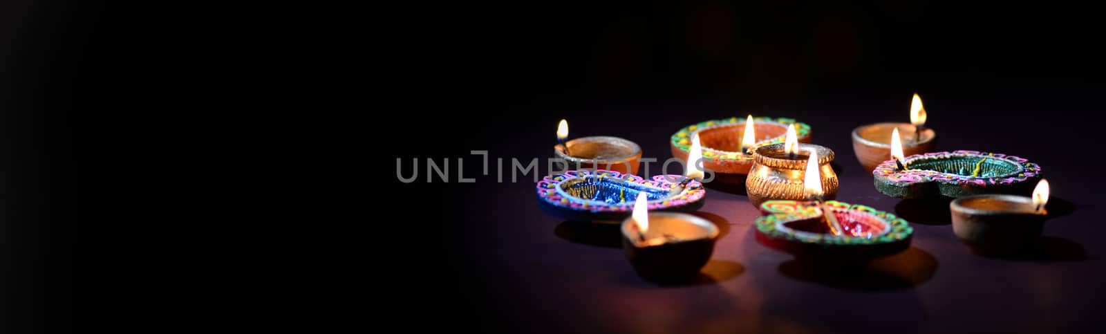 Clay diya lamps lit during diwali celebration. Greetings Card Design Indian Hindu Light Festival called Diwali