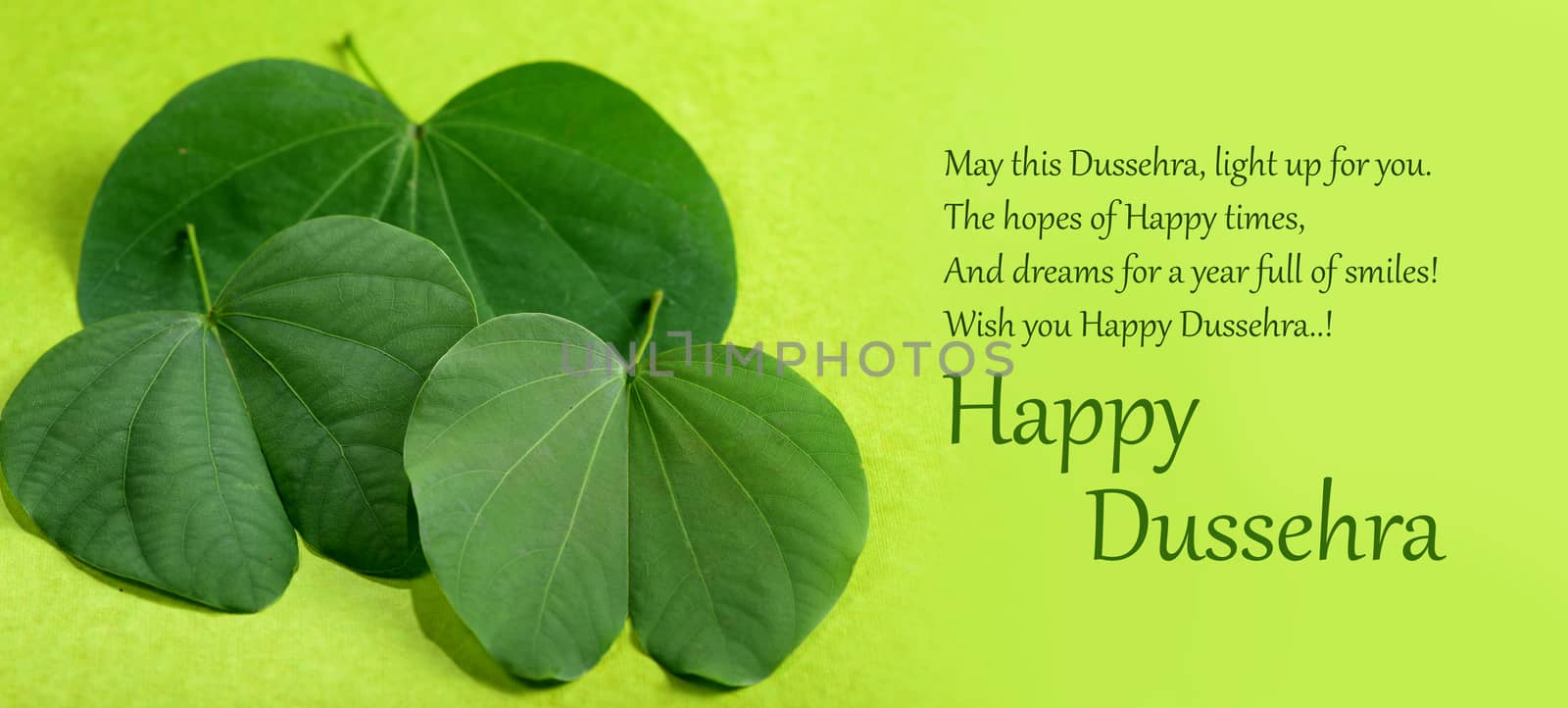 Indian Festival Dussehra, showing golden leaf and flowers on green background. Greeting card.