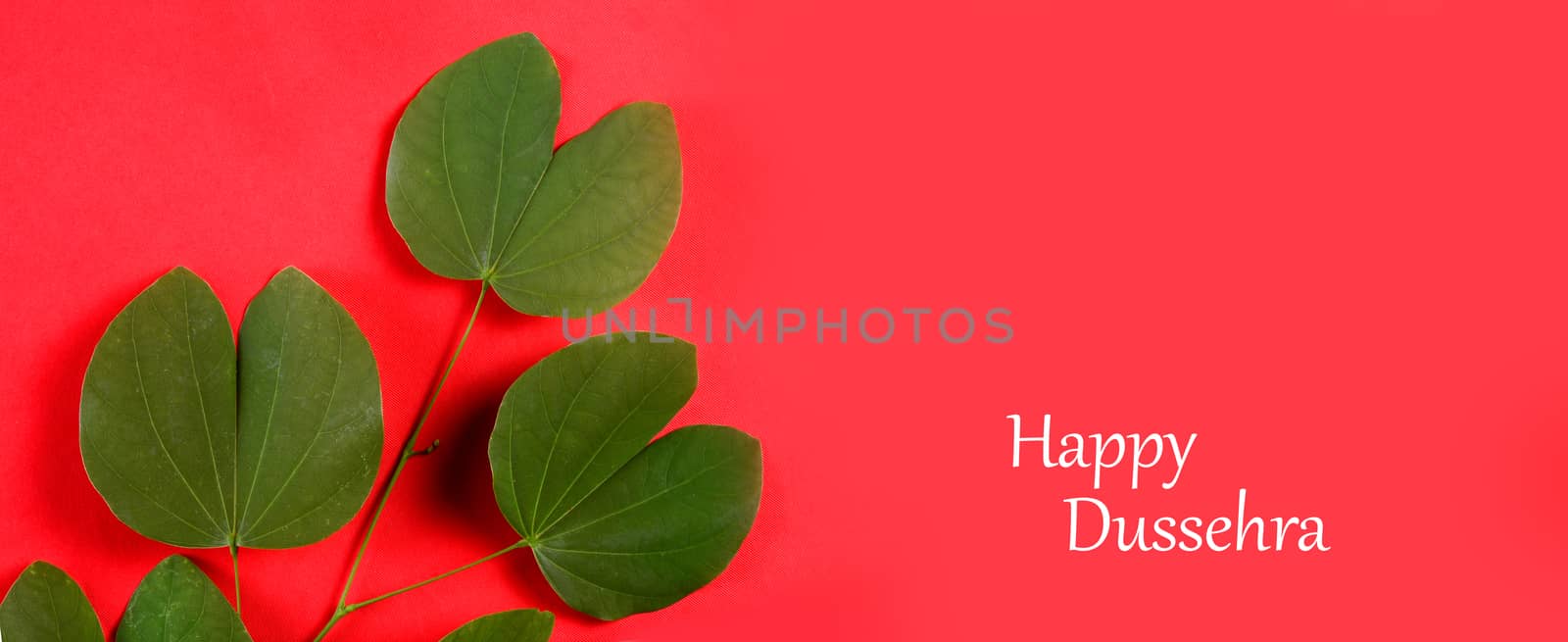 Indian Festival Dussehra, showing golden leaf on red background. Greeting card.