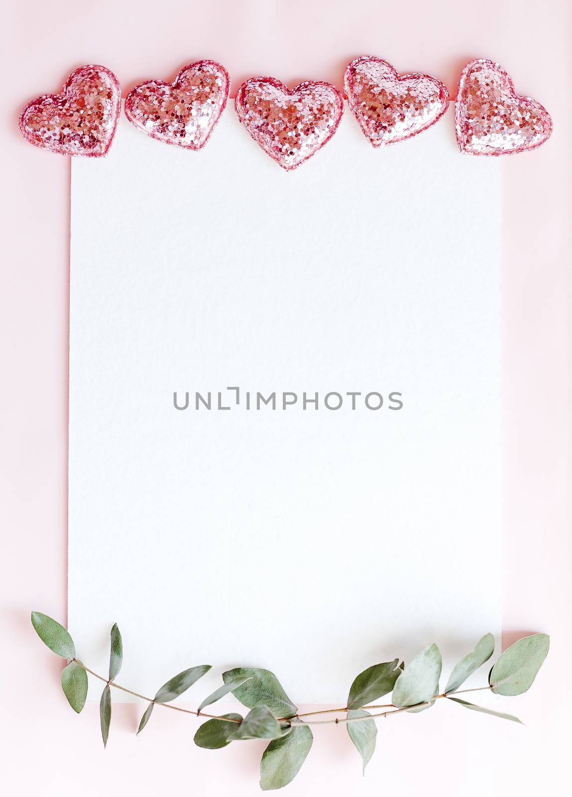 Background with copy space blank on pink background with pink glittered hearts, eucalyptus branch. White paper top view, flat lay, minimal style. Moke up card. by Denys_N