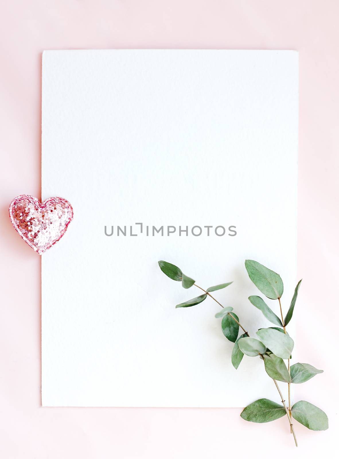 Background with copy space blank on pink background with pink glittered hearts, eucalyptus branch. White paper top view, flat lay, minimal style. Moke up card. by Denys_N