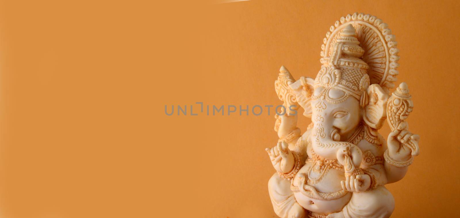 Hindu God Ganesha. Ganesha Idol on yellow background