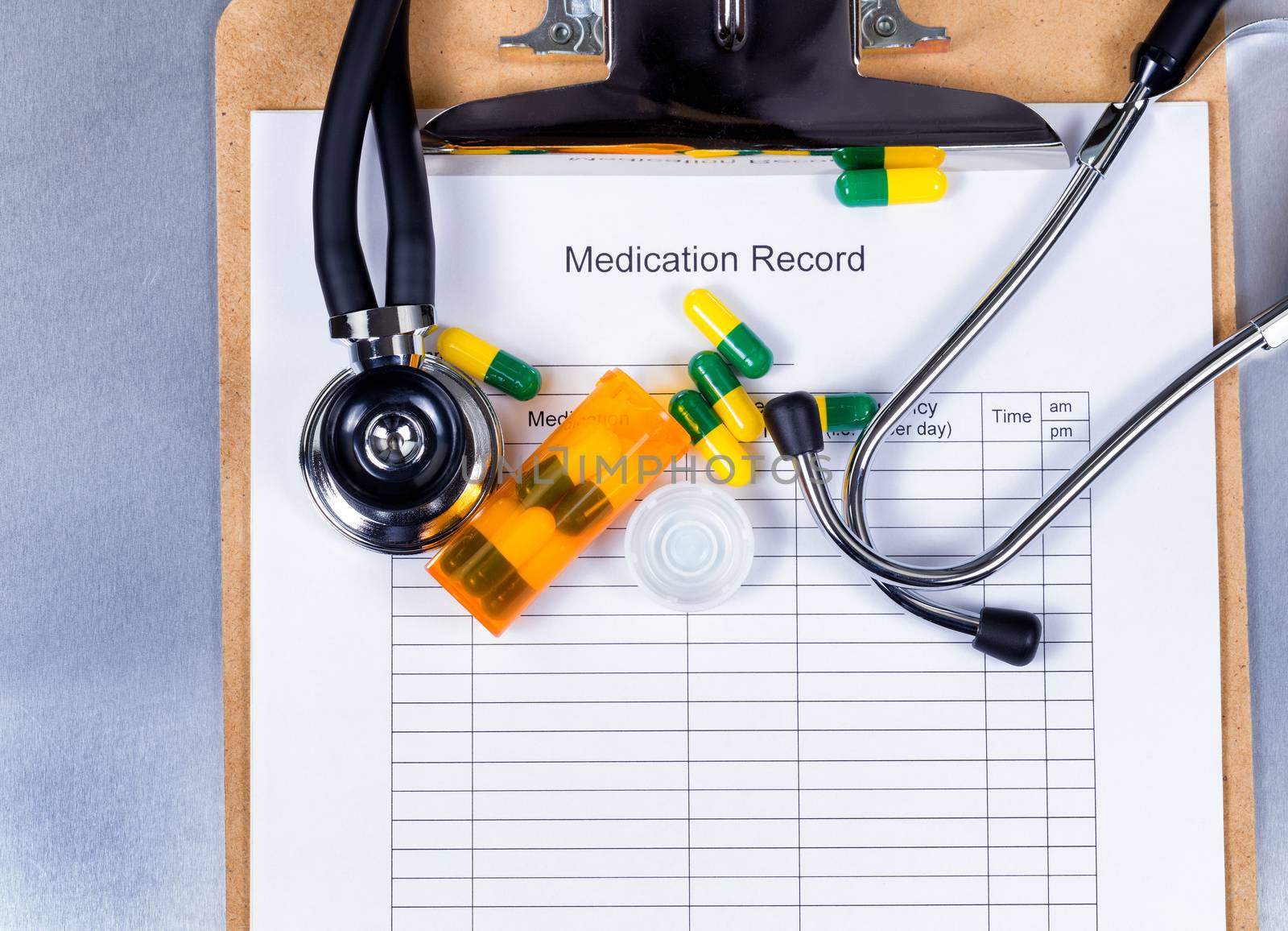 Clipboard with patient medication record plus pills and equipmen by tab1962