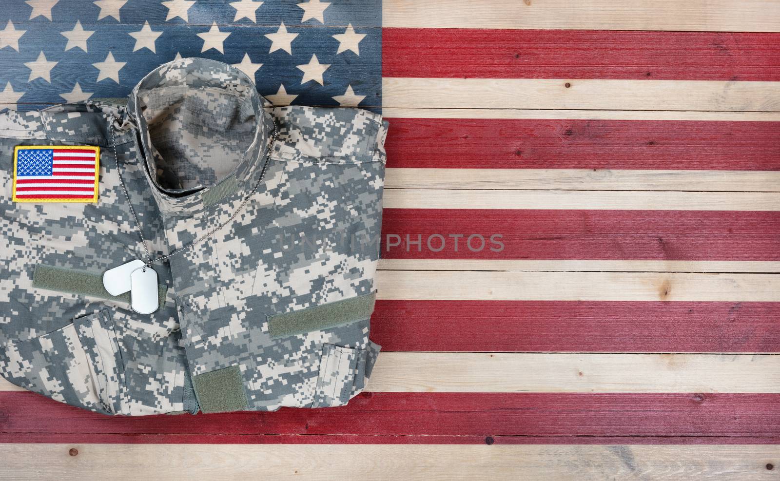 Overhead view of USA military uniform on rustic wooden flag by tab1962