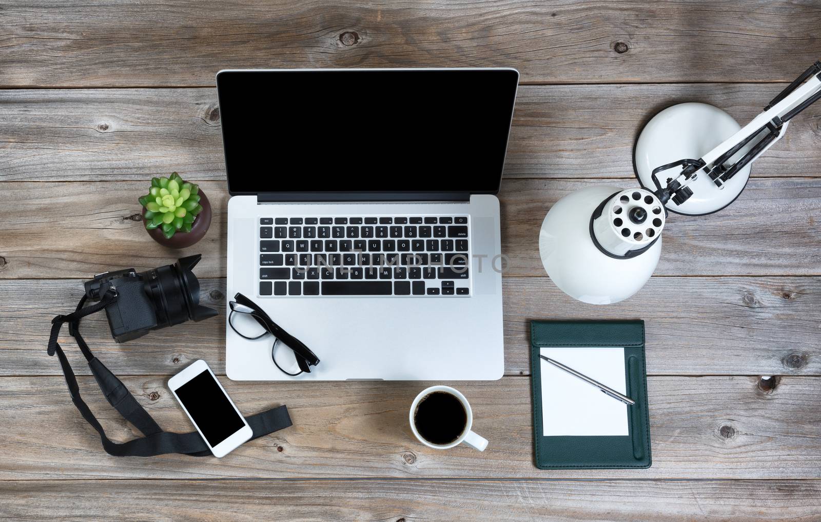 Technology with working desktop in overhead view on rustic wood  by tab1962