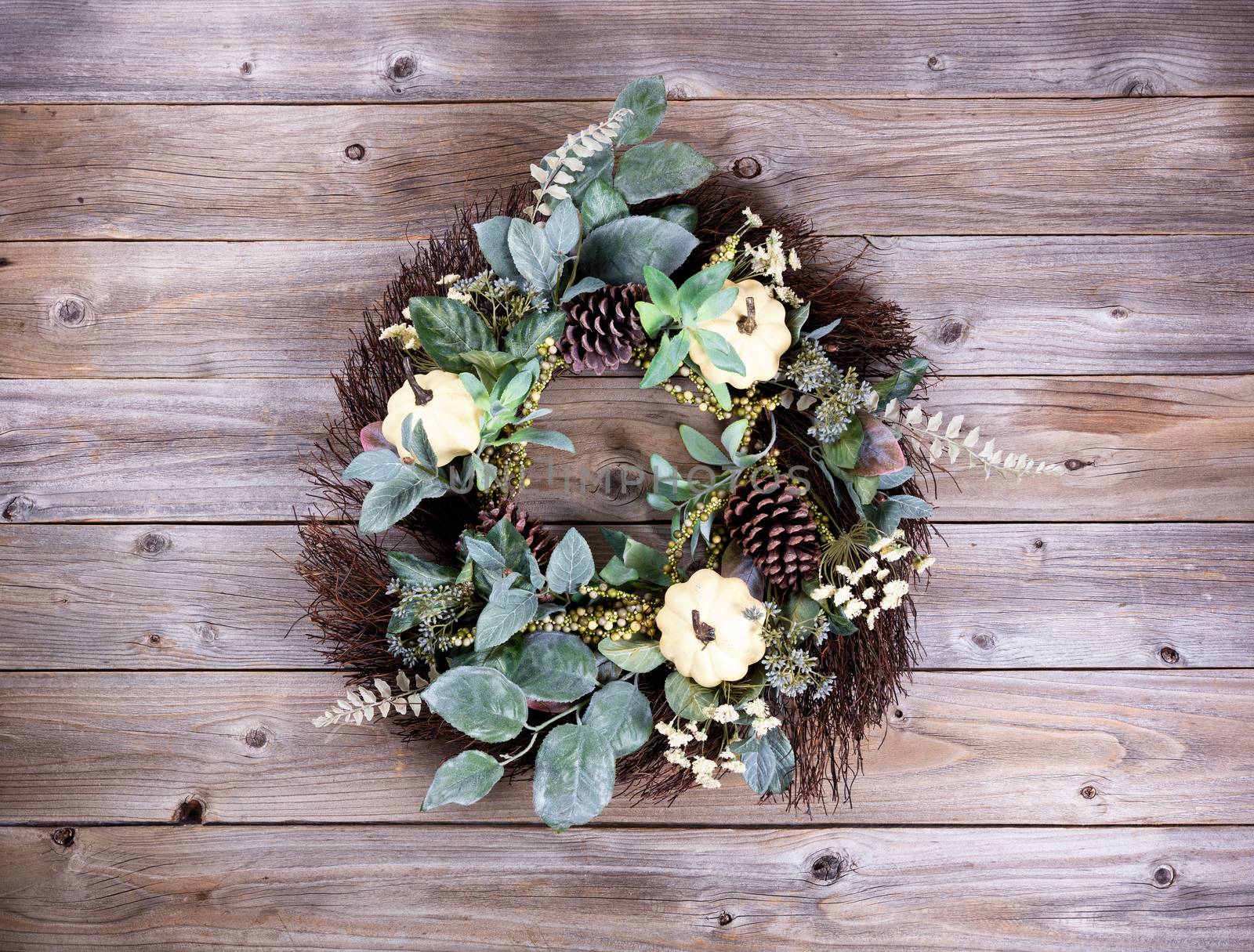 Autumn wreath on rustic wooden boards. 