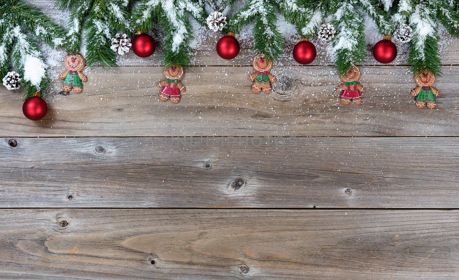 Top border of Christmas objects and snow on rustic wood for the holiday.     