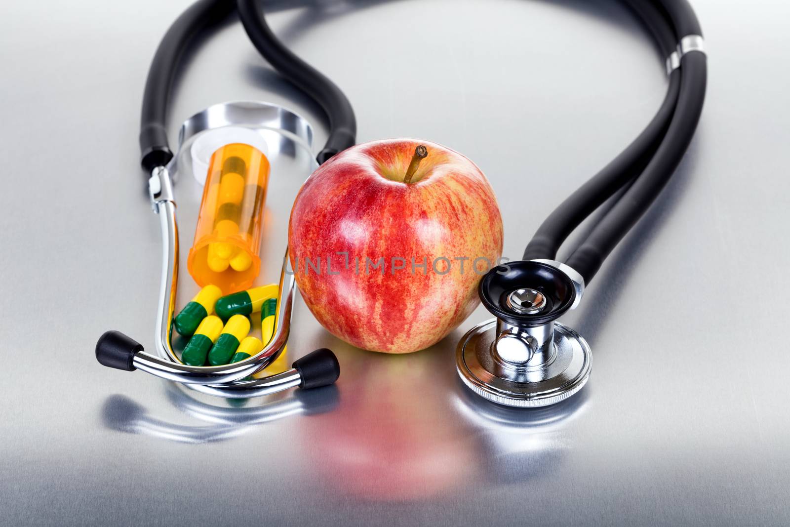 Health care concept with medicine bottle plus red apple and stet by tab1962