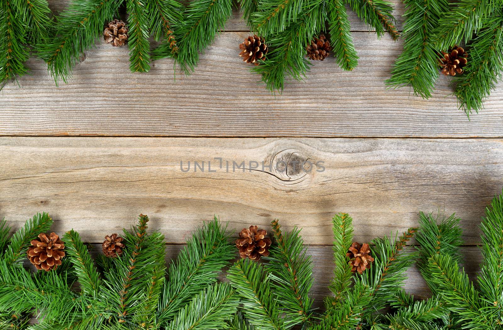 Christmas holiday border with evergreen branches on rustic cedar by tab1962