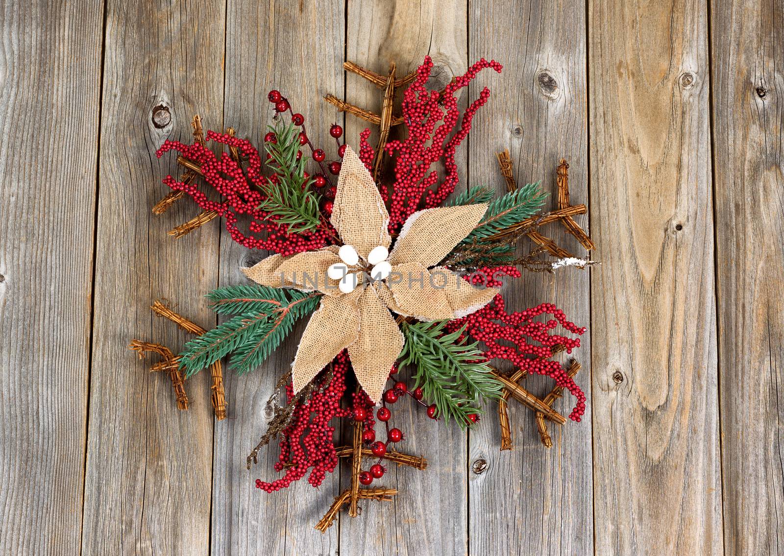 Christmas wreath with cloth flower on rustic wooden boards by tab1962