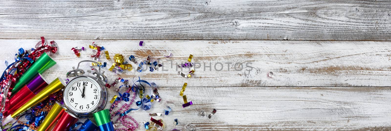 Happy New Year concept with clock at midnight on white weathered wood 
