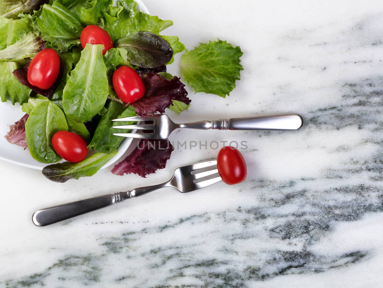 Organic healthy salad in flat view layout on natural marble.  