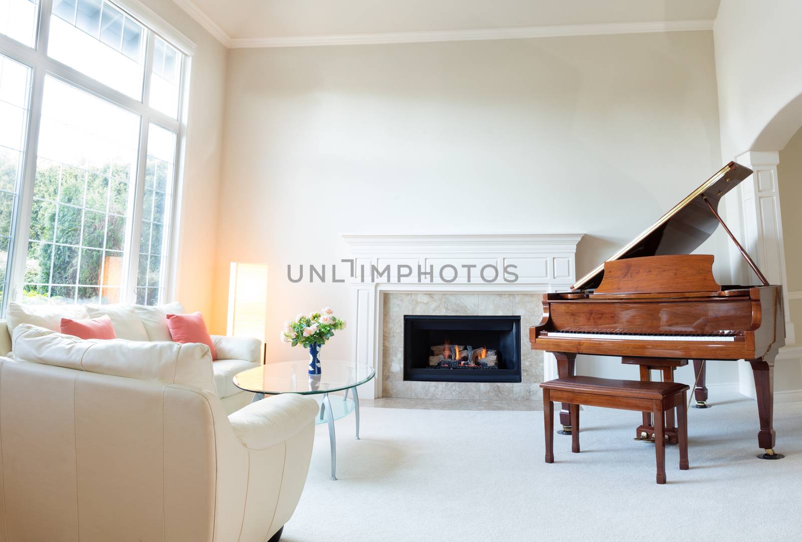 Living room decorated with leather sofa and piano with burning f by tab1962