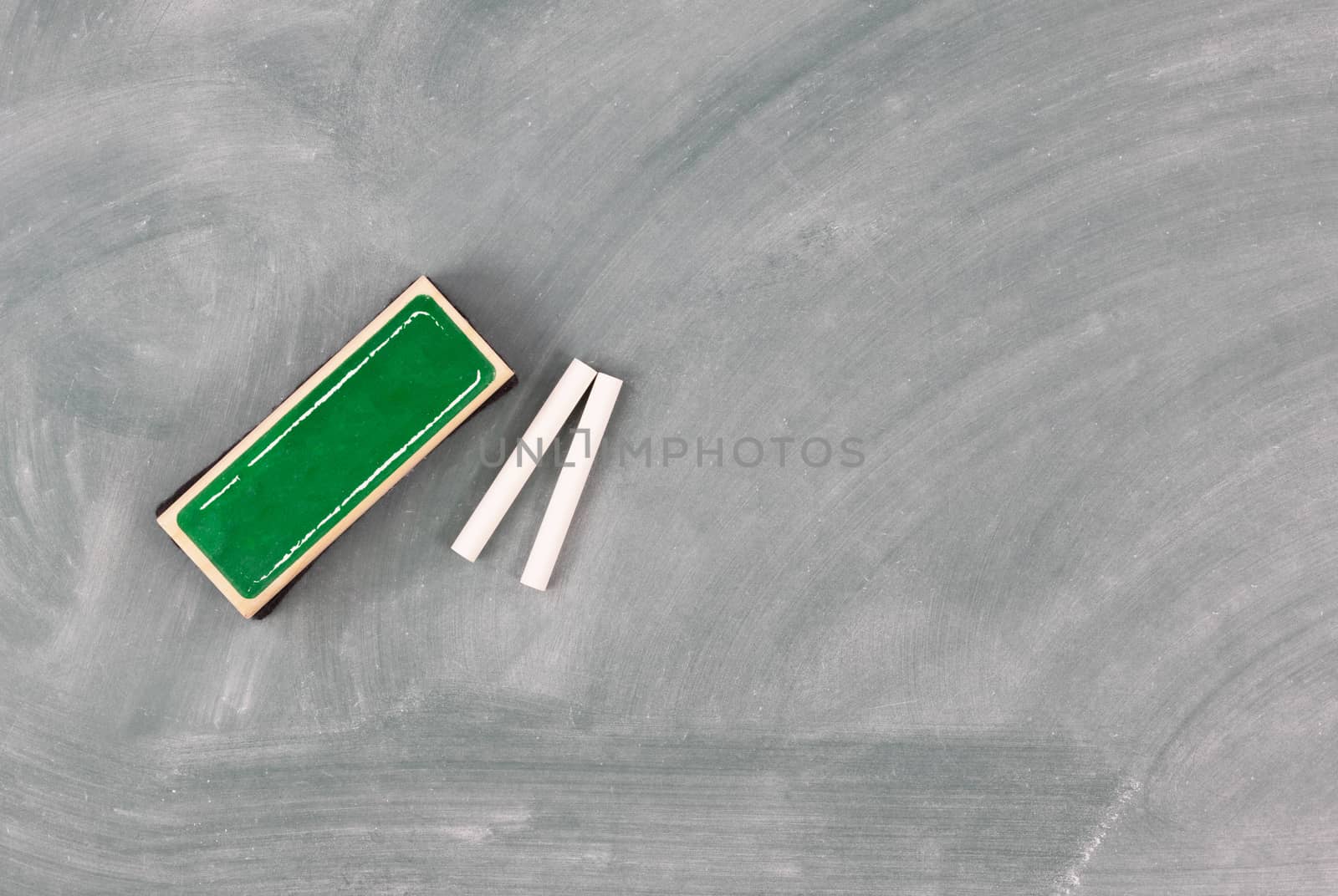 Back to school concept with green chalkboard plus eraser and cha by tab1962