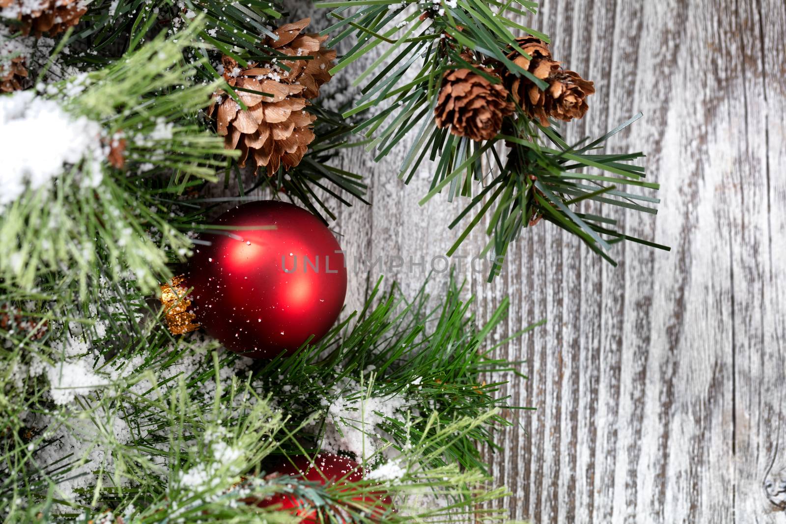 Close up of a red Christmas ball ornament on white rustic wood  by tab1962