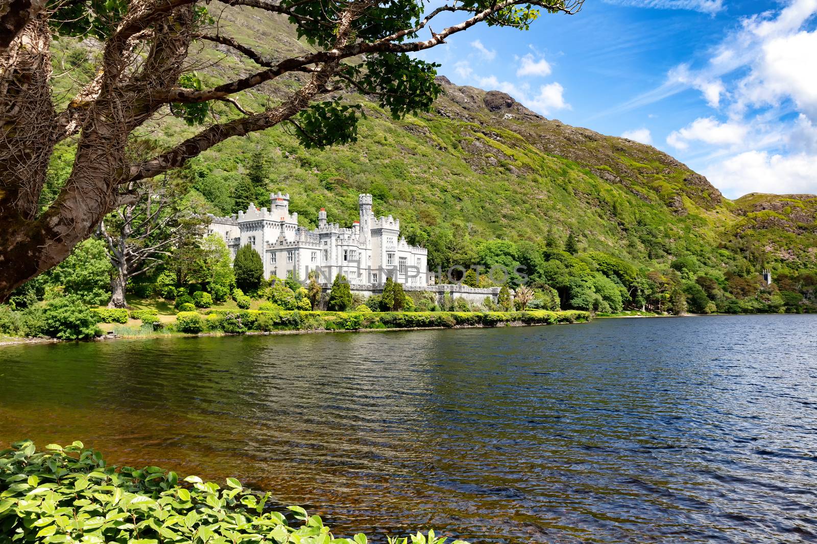 Kylemore Abbey in Connemara mountains with lake in front by tab1962