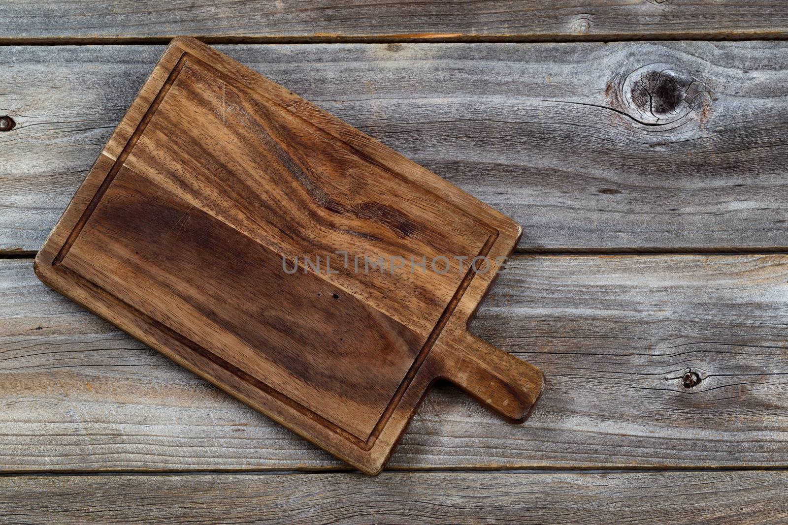 Vintage walnut wood serving board for food on aged wooden boards