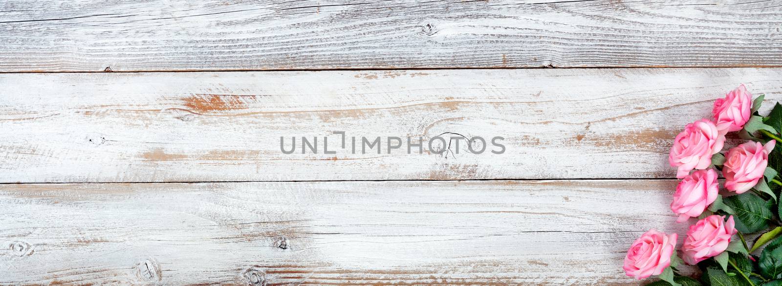 Spring image still life with Mothers Day holiday concept on white rustic background with pink rose flowers 