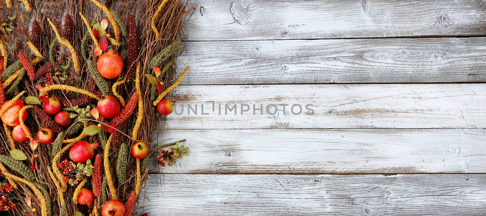 Thanksgiving decorations on left side of white rustic wood 