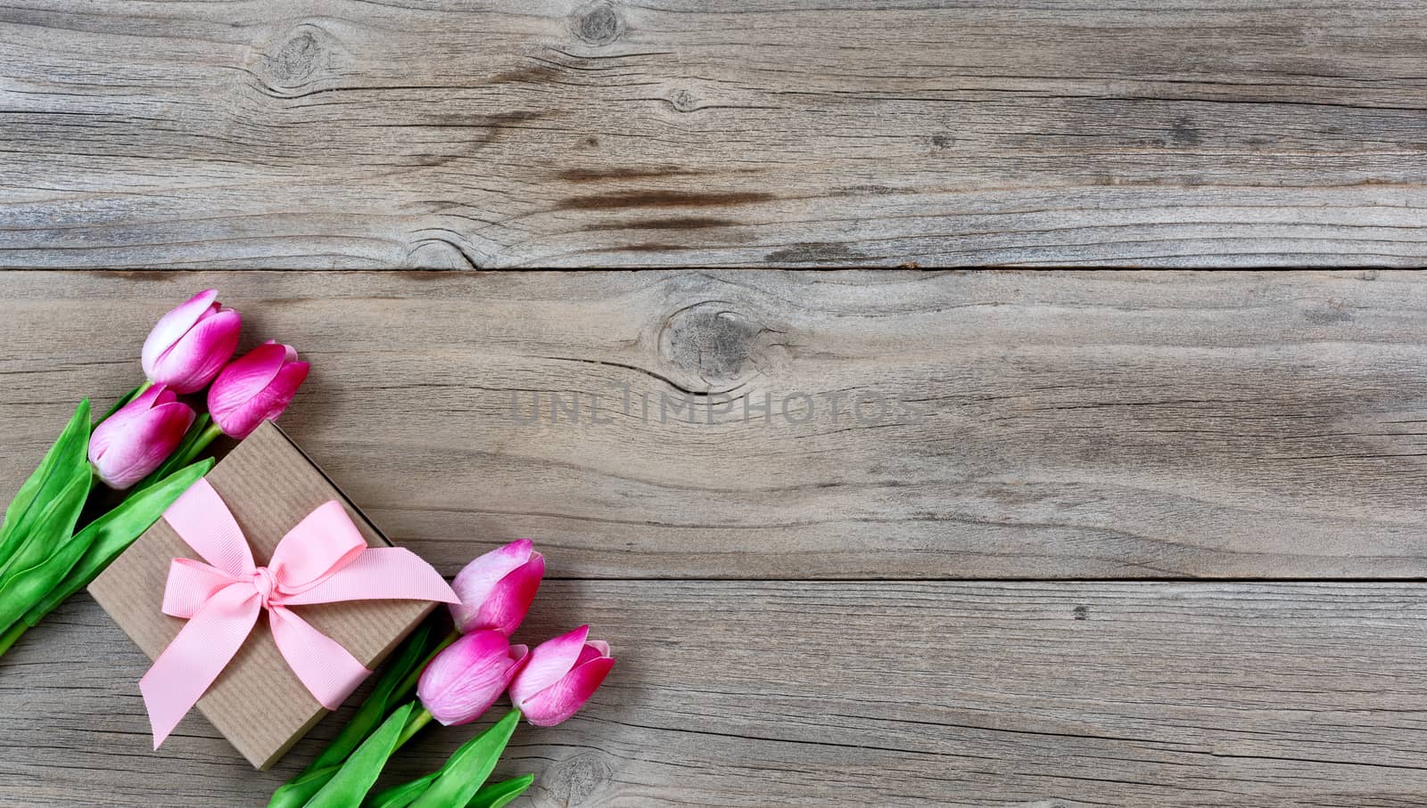 Tulips and gift for Mothers day on rustic wooden background by tab1962