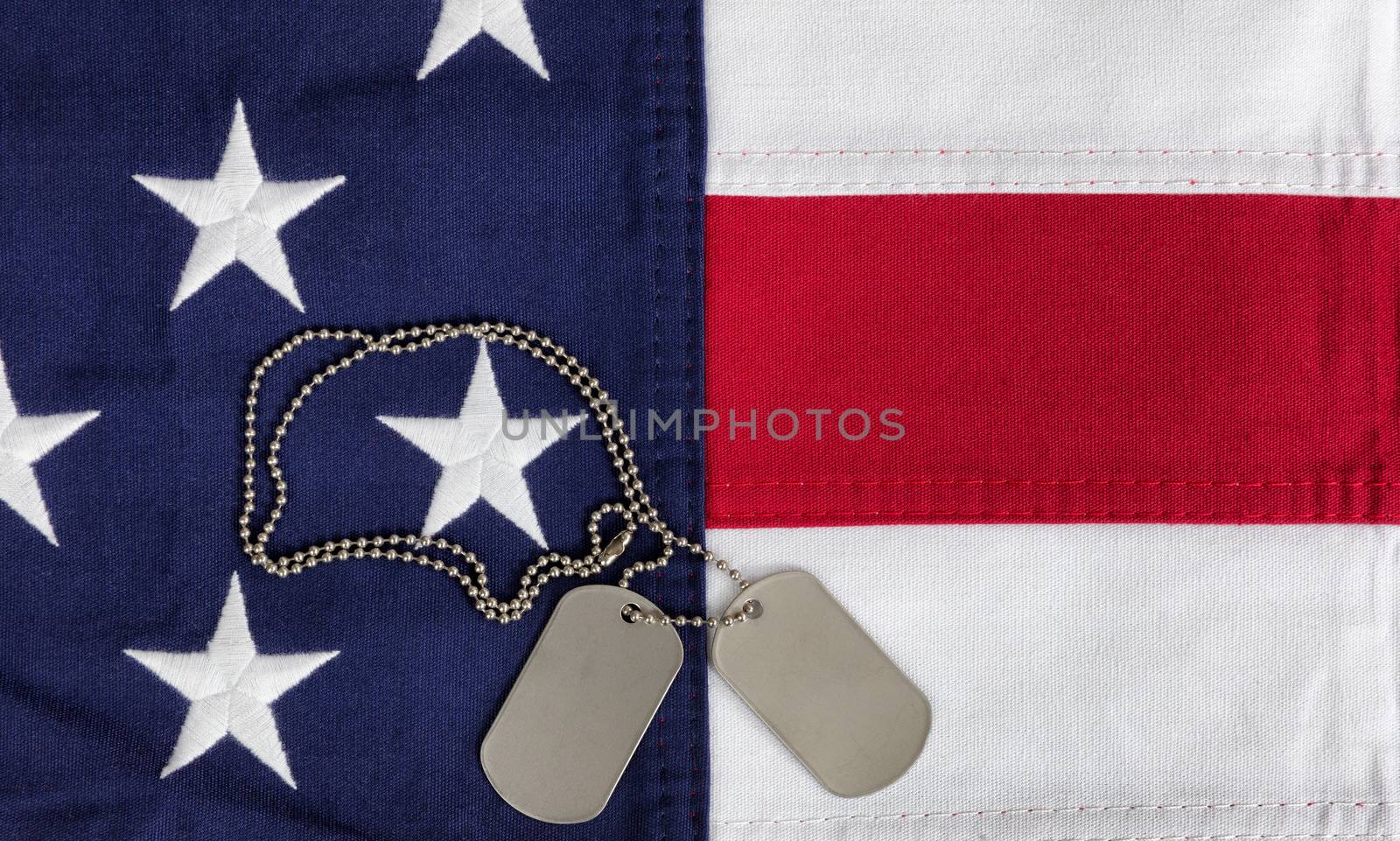 Cloth United States flag with military ID tags in overhead view  by tab1962