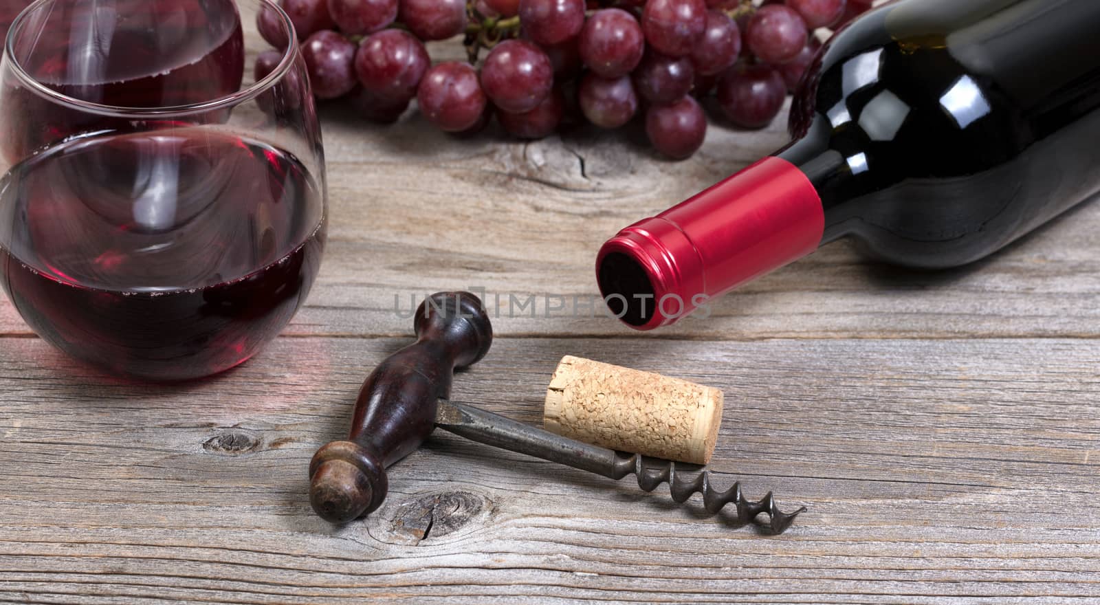 Vintage corkscrew with red wine bottle with grapes and glasses i by tab1962