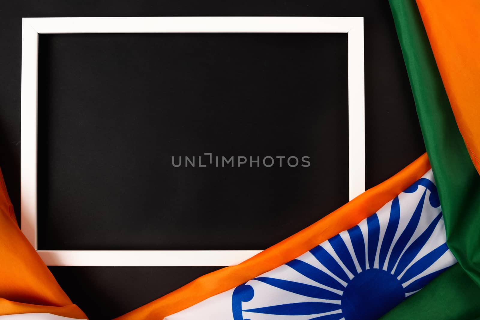 Indian republic day, flat lay top view, Indian flag and photo frame on black background with copy space for your text