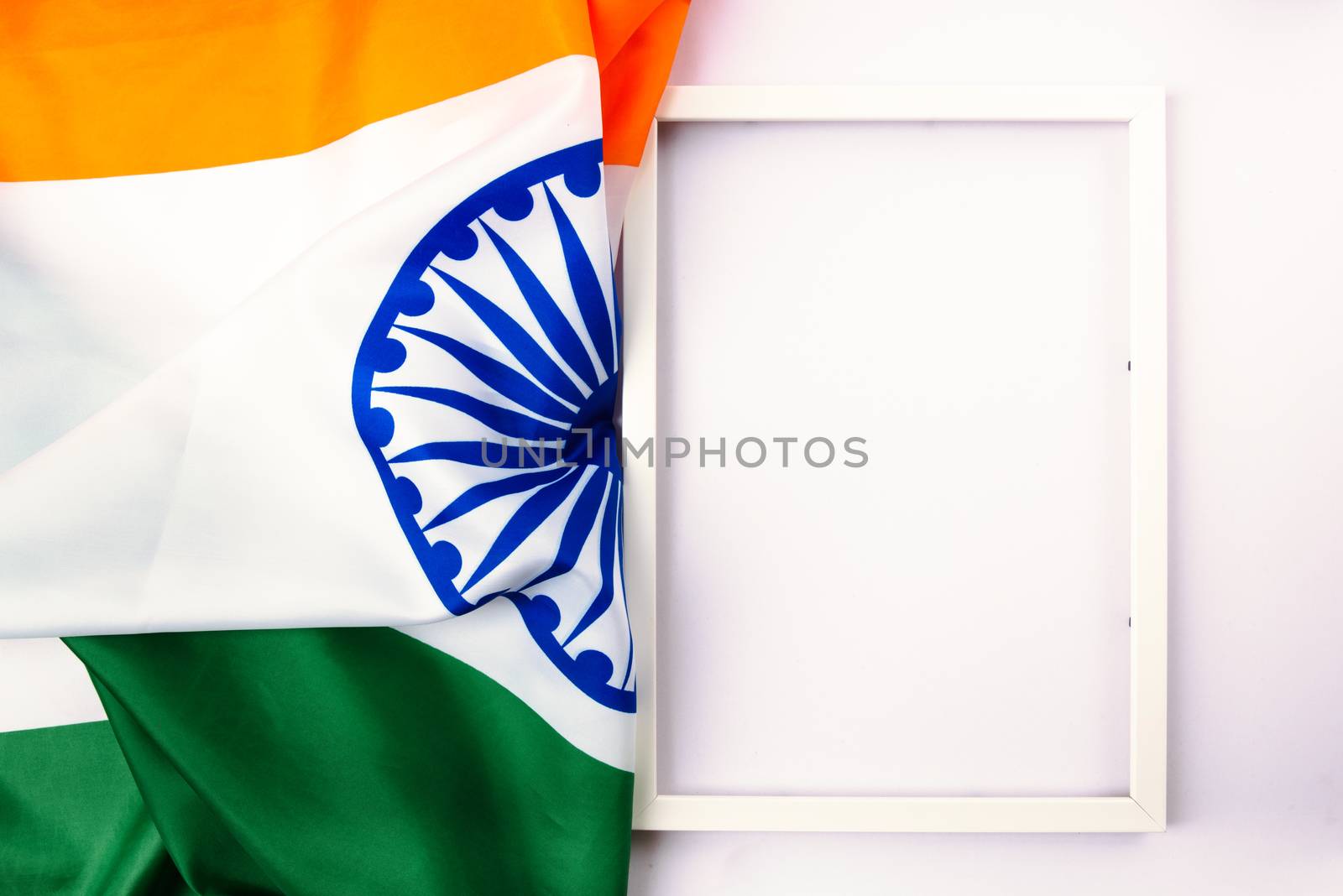Indian republic day, flat lay top view, Indian tricolor flag and photo frame on white background with copy space for your text