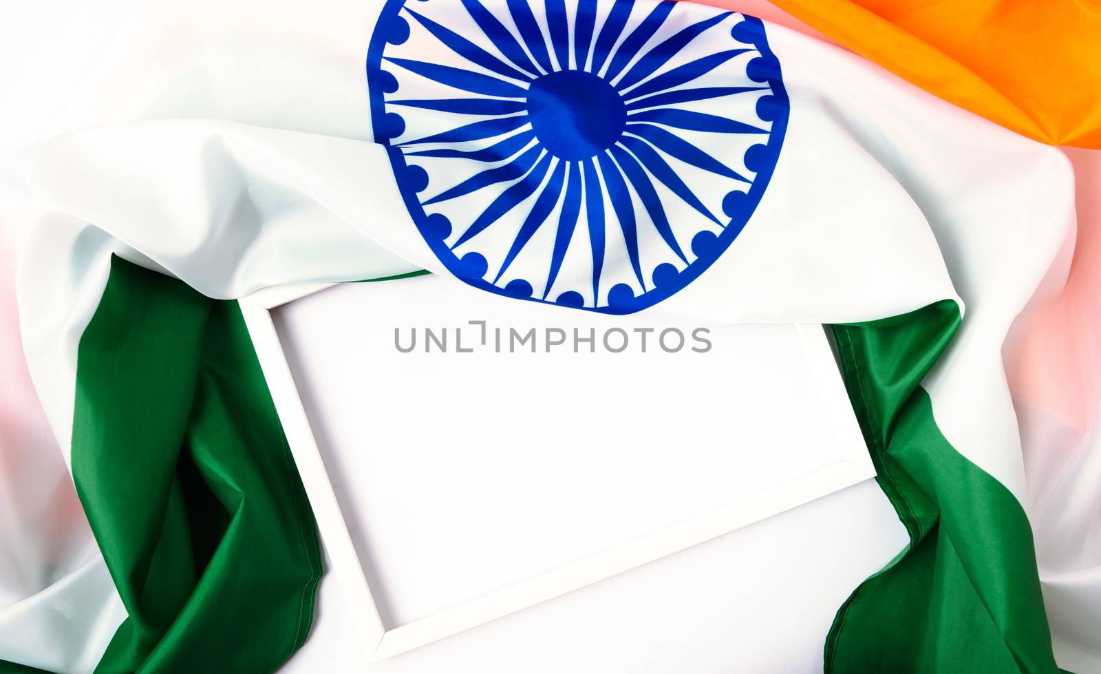 Indian republic day, flat lay top view, Indian tricolor flag and photo frame on white background with copy space for your text