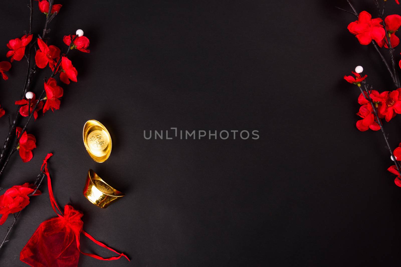 Chinese New Year, flat lay top view, gold bar and Chinese Flower on black background with copy space for your text