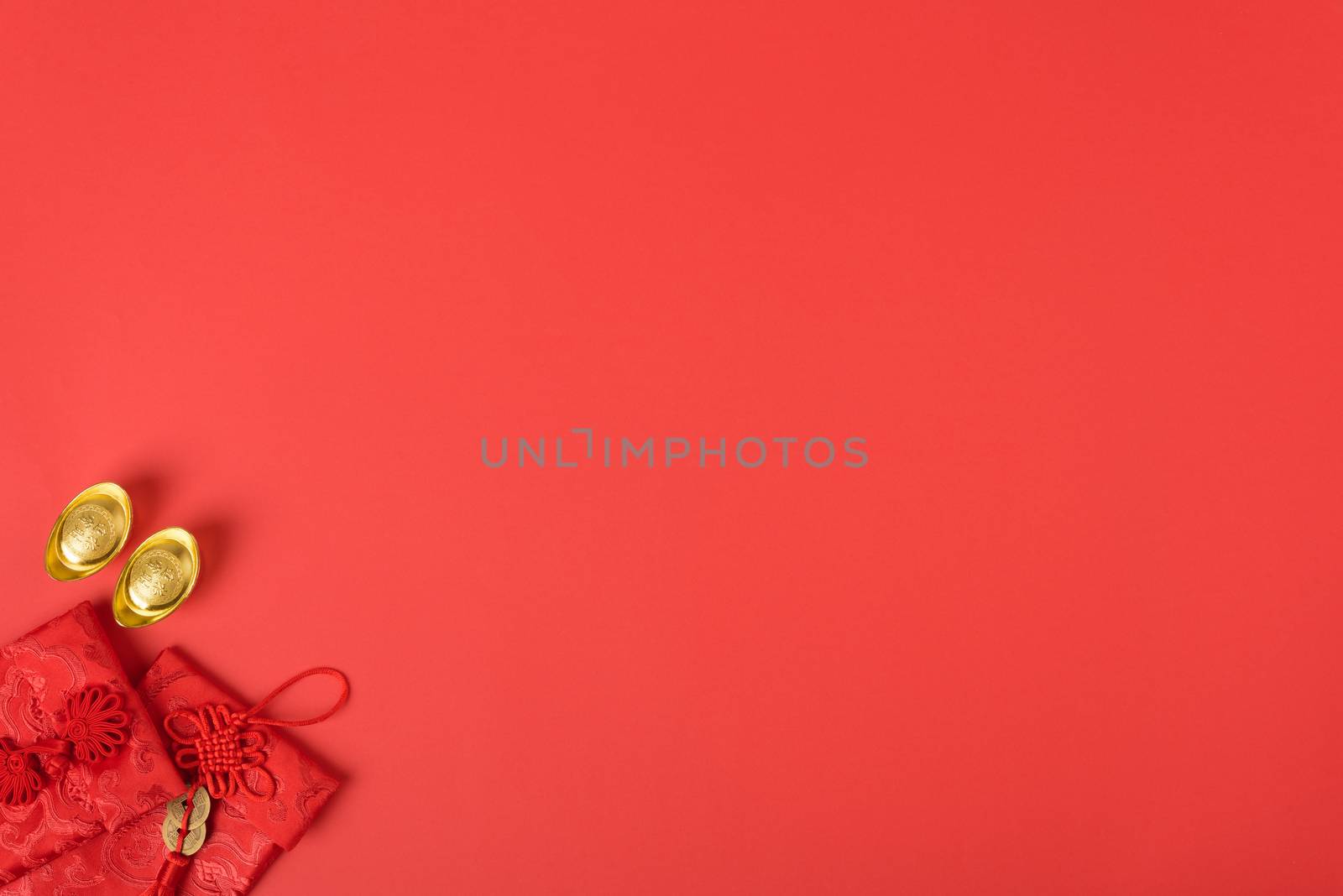 Chinese new year concept, flat lay top view, Happy Chinese new year with Red envelope and gold ingot (Character "FU" means fortune, blessing, wealth) on red background with copy space for your text
