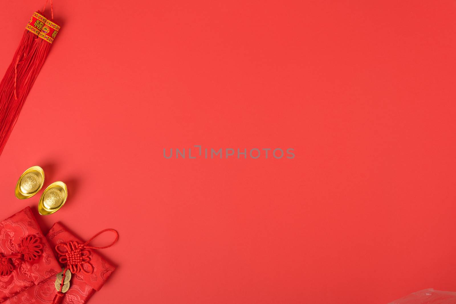 Chinese new year concept, flat lay top view, Happy Chinese new year with Red envelope and gold ingot (Character "FU" means fortune, blessing, wealth) on red background with copy space for your text