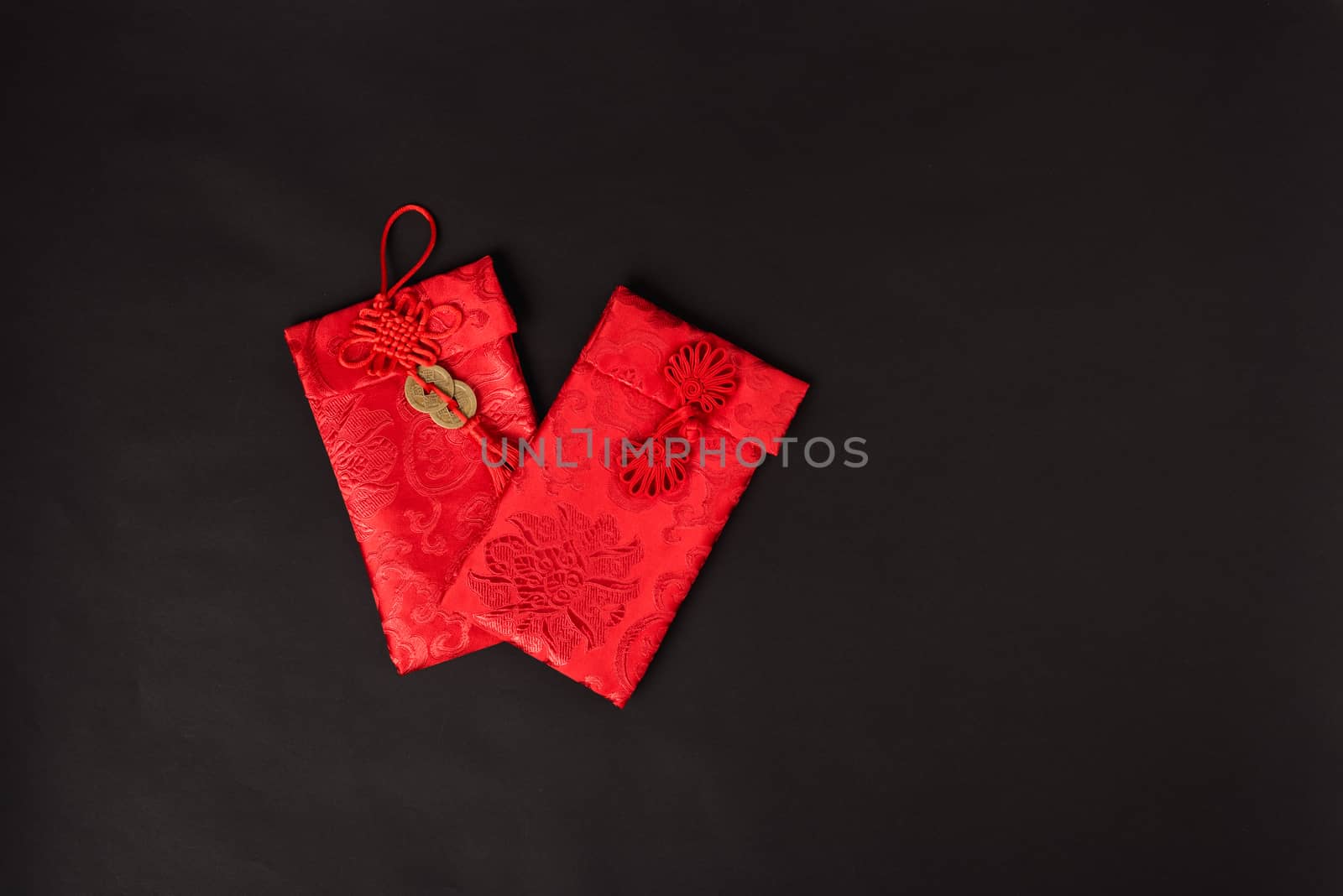 Chinese new year festival concept, flat lay top view, Happy Chinese new year with Red envelope (Character "FU" means fortune, blessing, wealth) on black background with copy space for your text