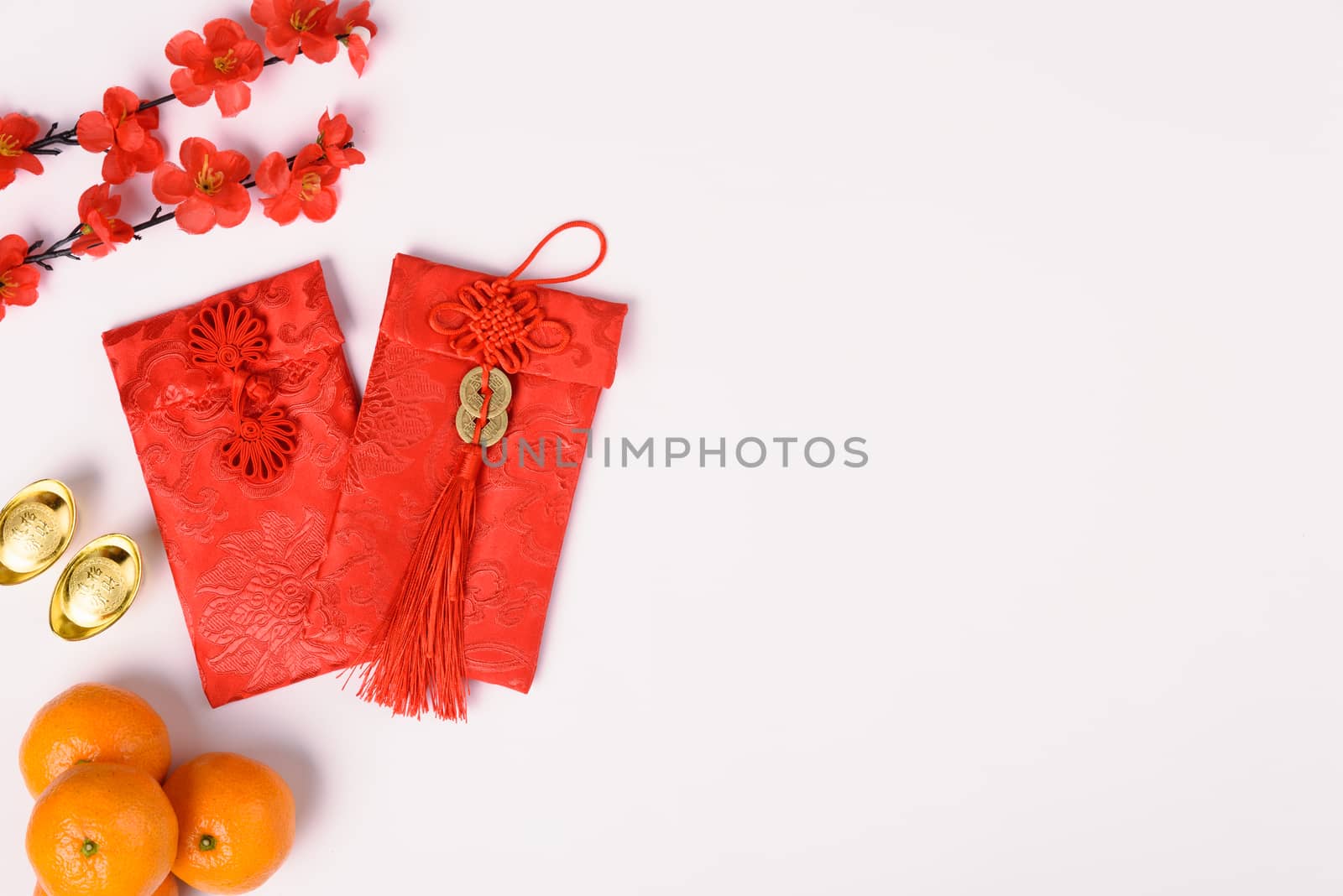 Chinese new year festival concept, flat lay top view, Happy Chinese new year with Red envelope and gold ingot (Character "FU" means fortune, blessing) on white background with copy space for text