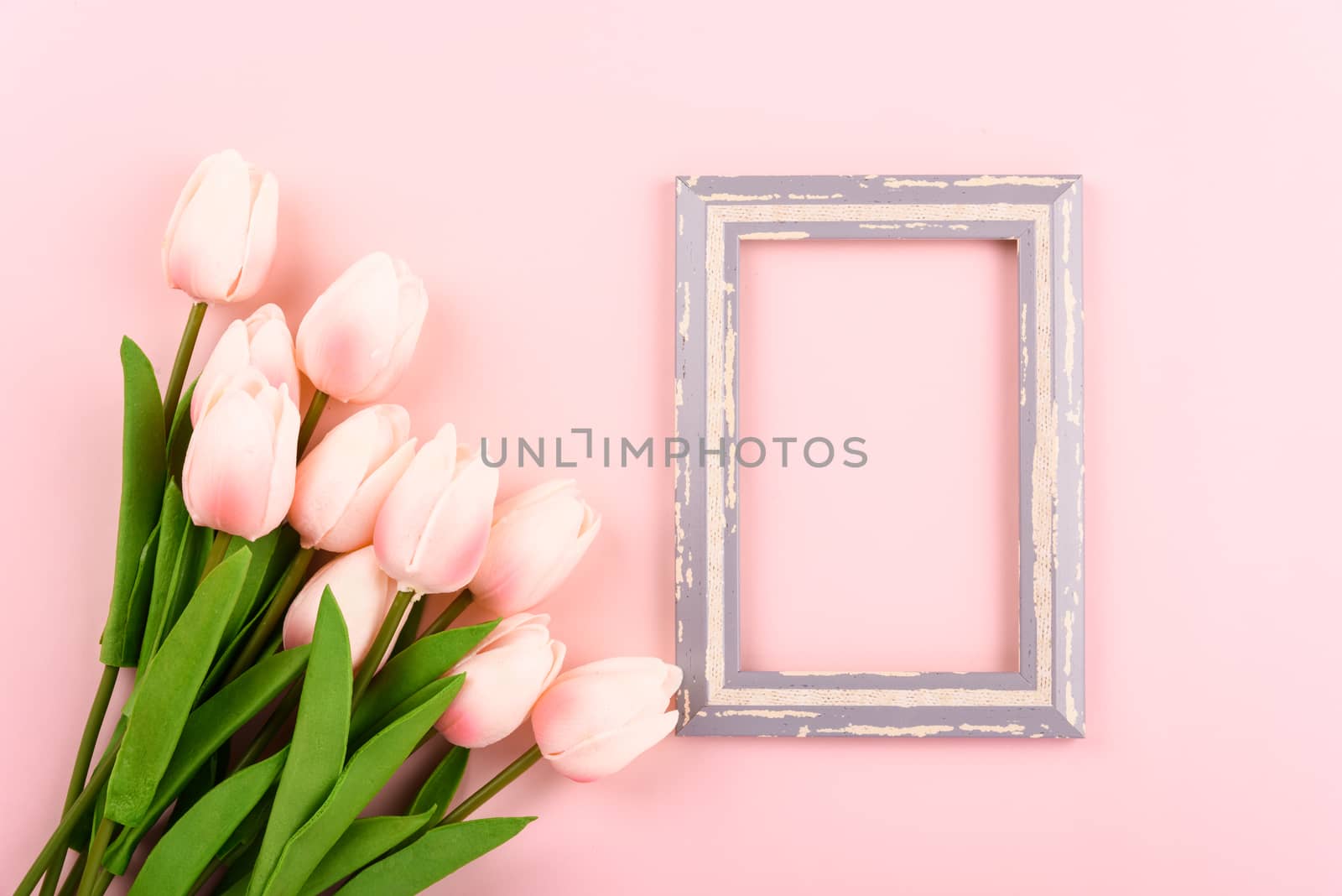 Happy Women's Day, Mother's Day concept. top view flat lay photo frame and Tulip flower on pink background, copy space for your text