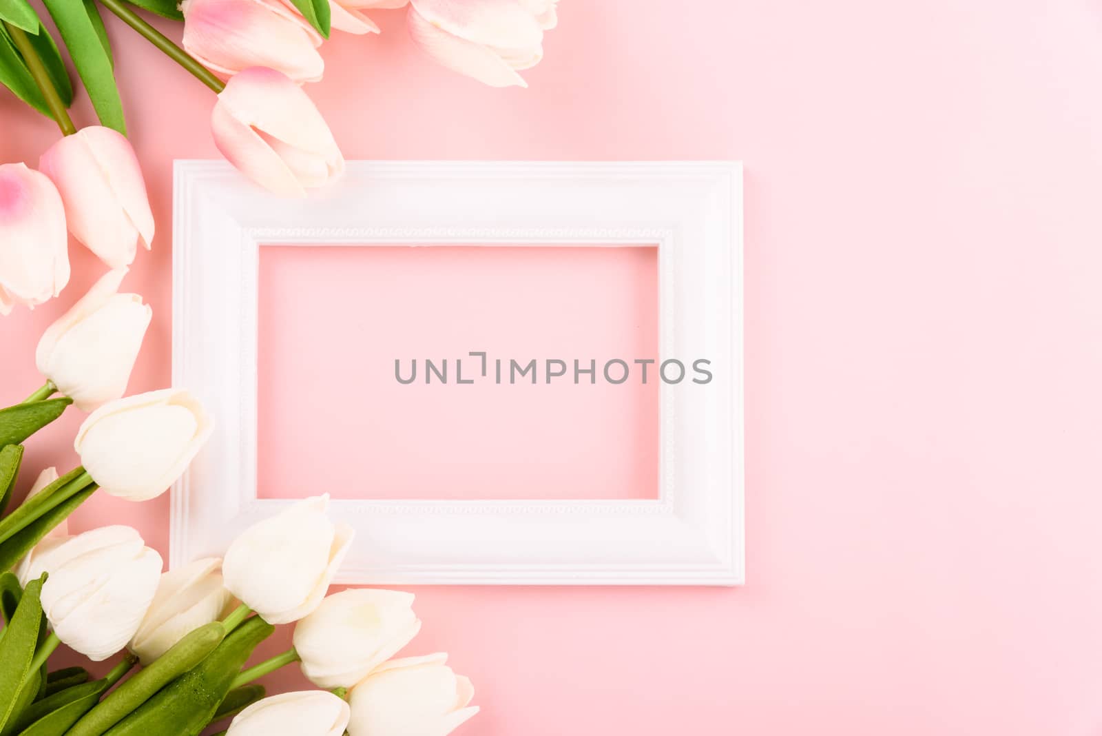 Happy Women's Day, Mother's Day concept. top view flat lay Tulip flower and photo frame on pink background, copy space for your text