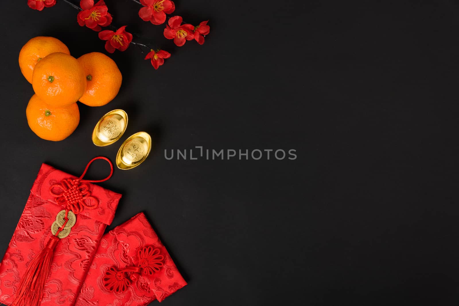 Chinese new year festival concept, flat lay top view, Happy Chinese new year with Red envelope and gold ingot (Character "FU" means fortune, blessing) on black background with copy space for text