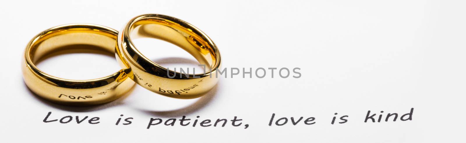 Golden wedding rings on bible phrase by Yellowj