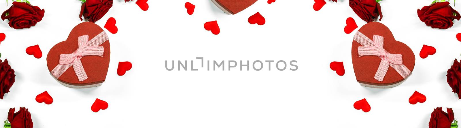 Red heart shaped gift box with roses and paper hearts isolated on white background