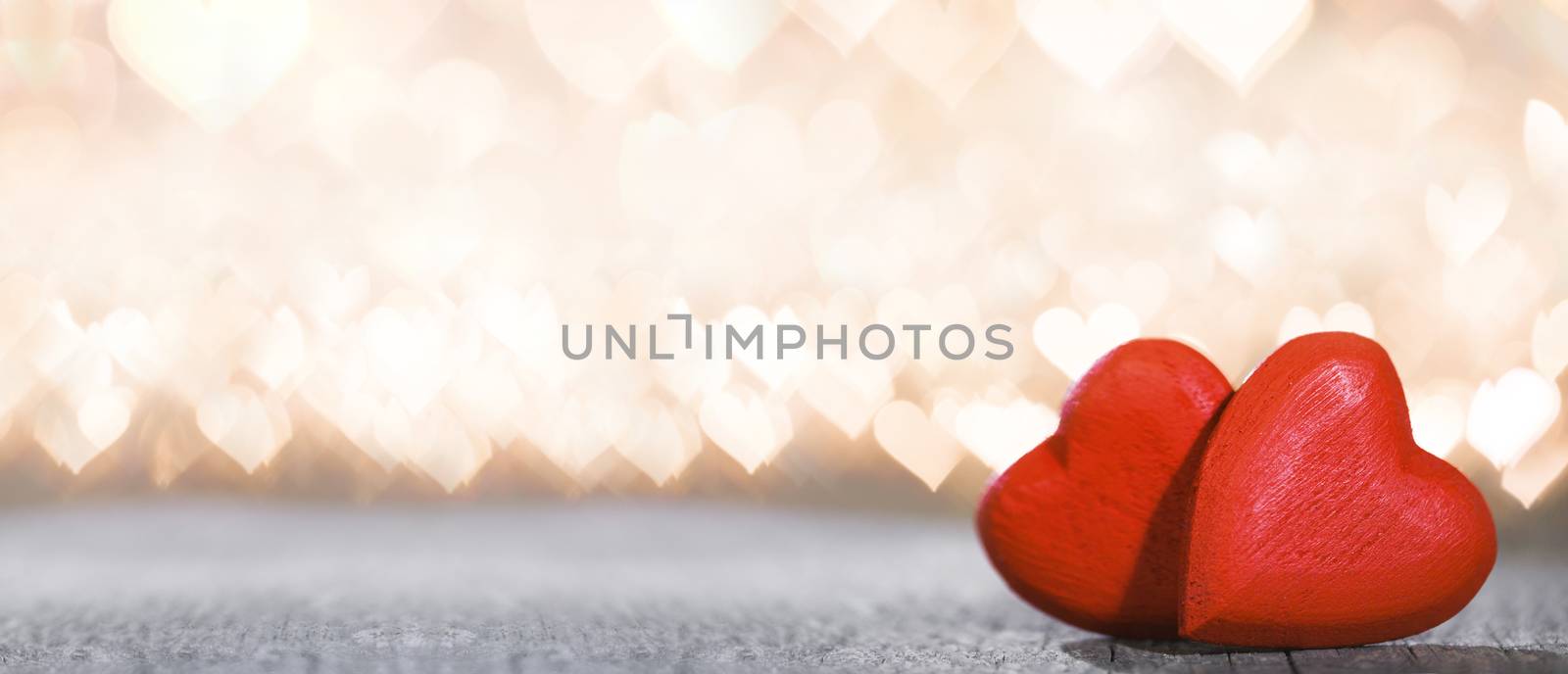 Two red wooden hearts symbol of love on background with beautiful bokeh party lights, Saint Valentine Day celebration