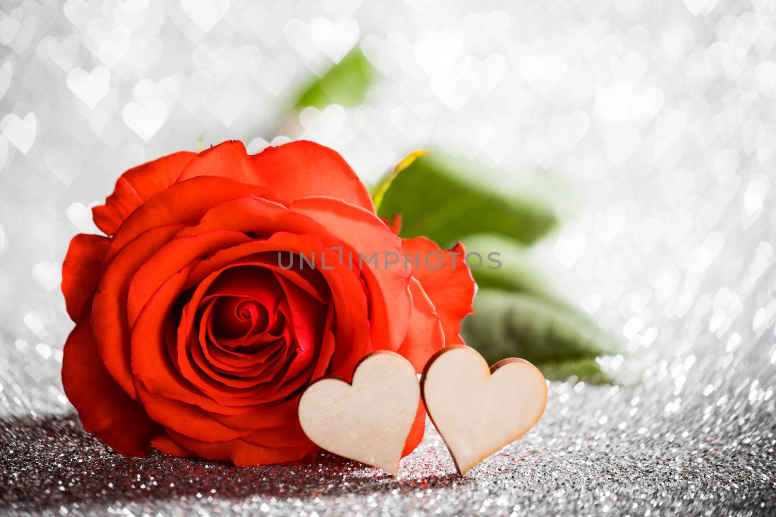 Rose and hearts on silver glowing bokeh hearts background for Valentines day