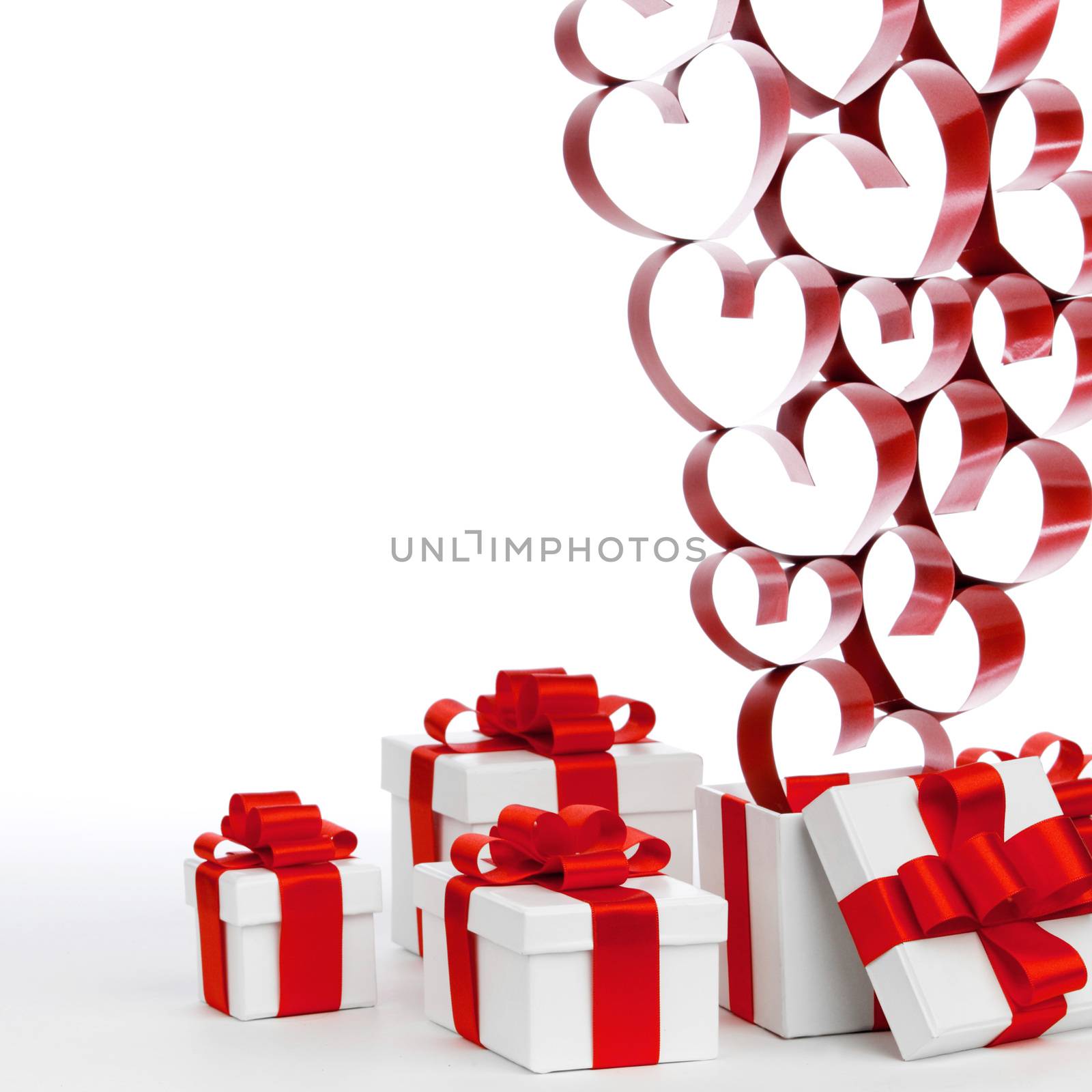 White boxes with red ribbons and decorative hearts isolated on white background