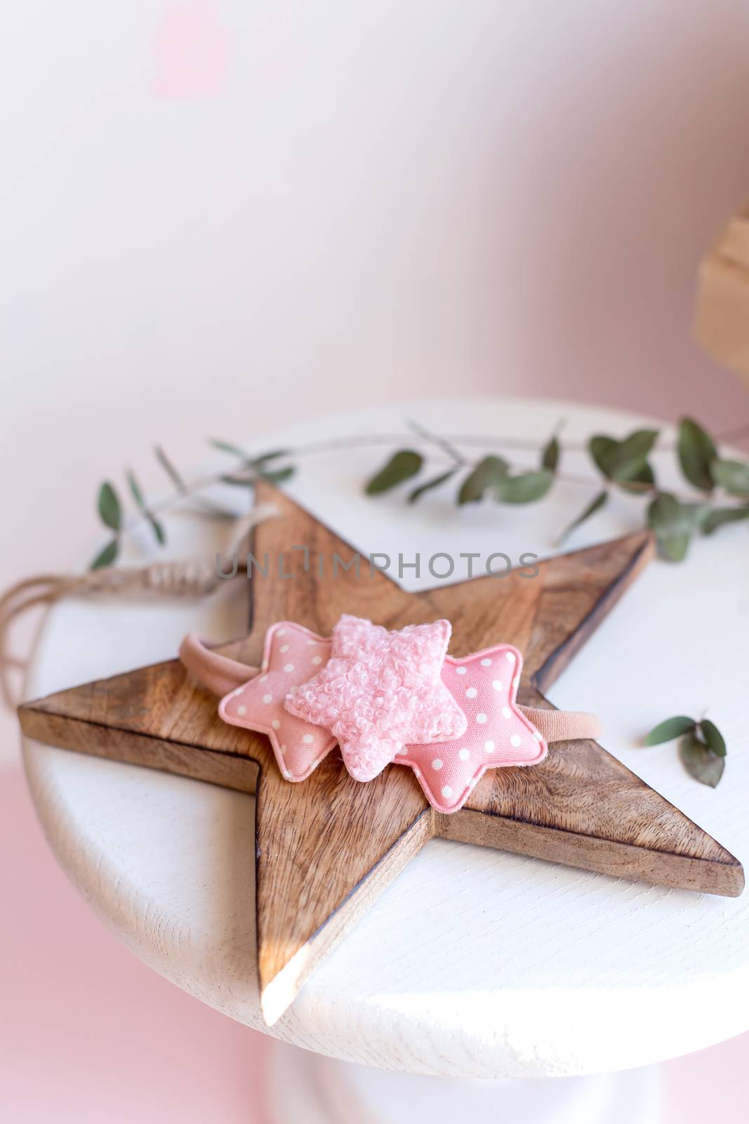 Beautiful fashion accessory for baby girls. Handmade accessories lace and stars on elastic band on white and brown background. Concept of children's clothing