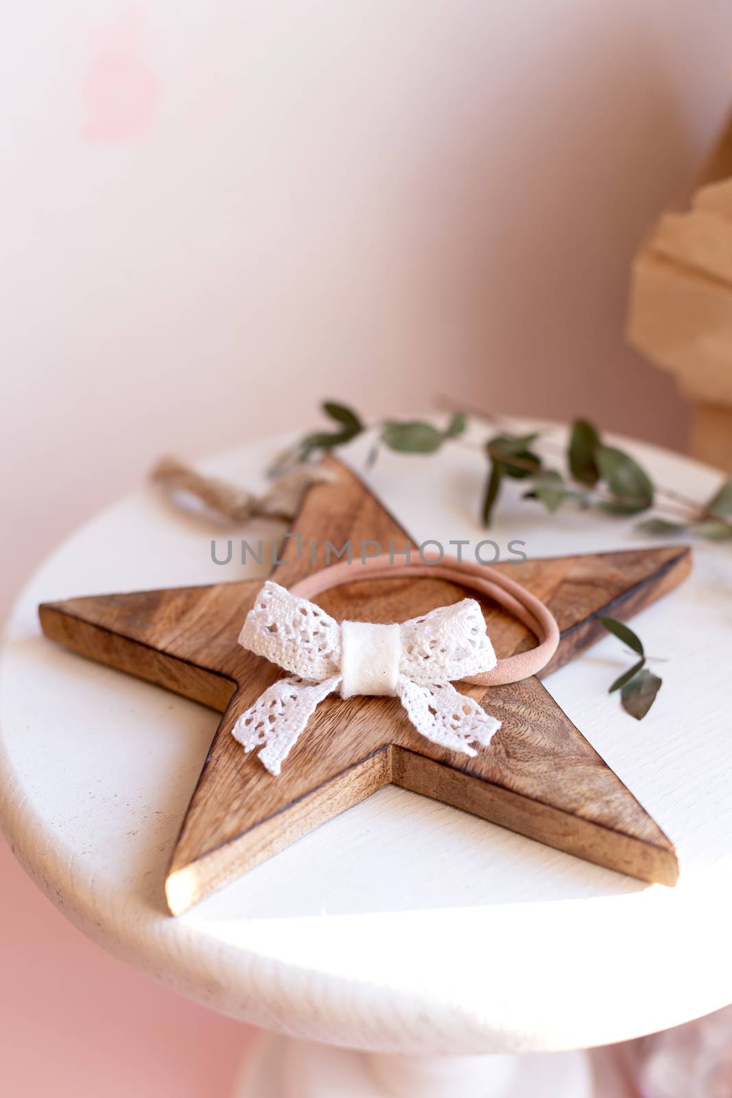 Beautiful fashion accessory for baby girls. Handmade accessories lace and stars on elastic band on white and brown background. Concept of children's clothing