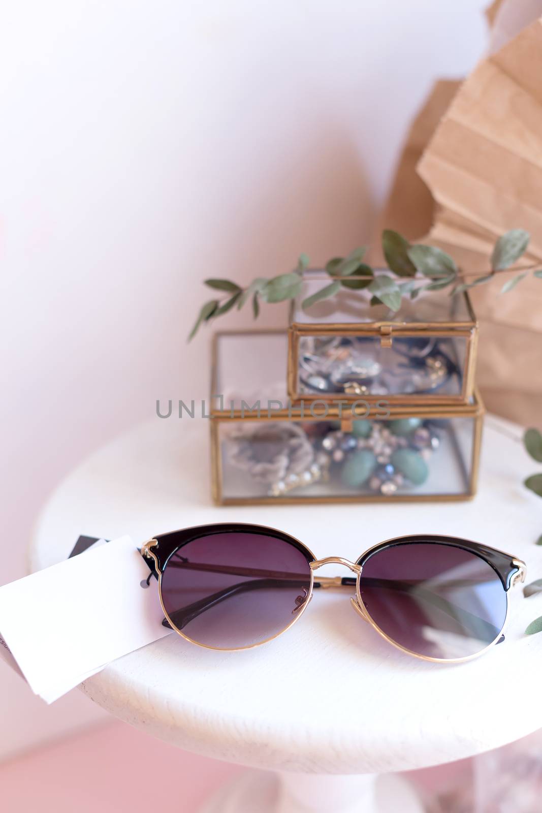 Beautiful fashion accessory for woman. Sunglasses on white and brown background. Copy space moke up accessories