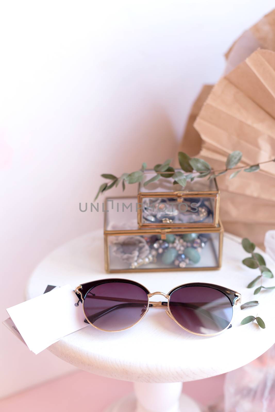 Beautiful fashion accessory for woman. Sunglasses on white and brown background. Copy space moke up accessories