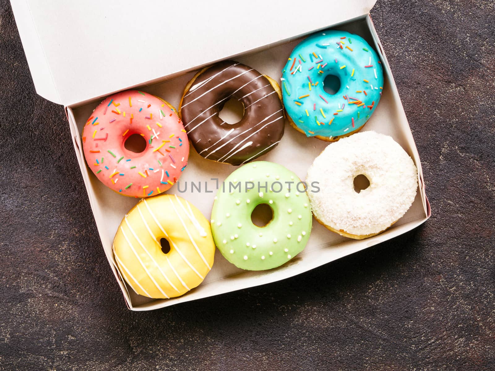paper box with colorful donuts, top view, copy space by fascinadora